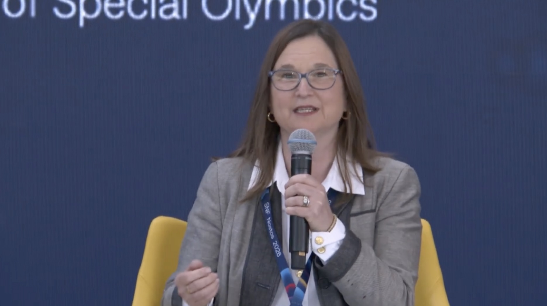Sharon Cohen speaking into a microphone on a panel